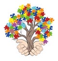 Hands holding a tree with puzzles. autism. vector illustration. Royalty Free Stock Photo